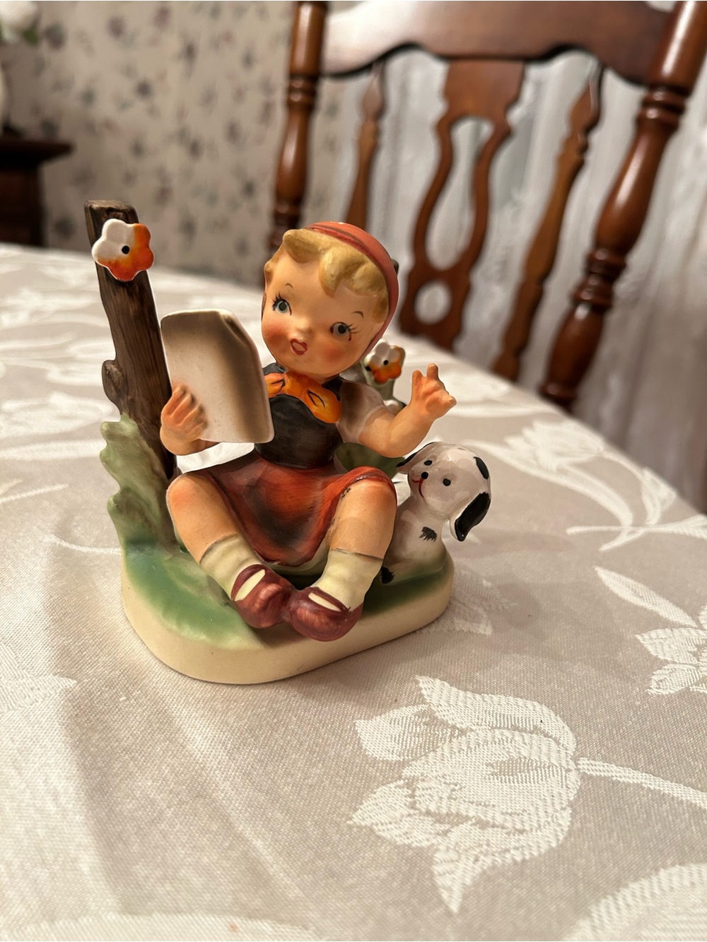 girl reading book with Dalmatian knick knack